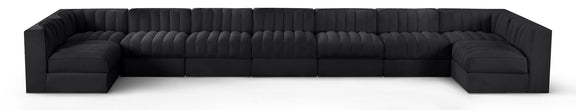 Black velvet modular sectional sofa with tufted cushions and curved armrests