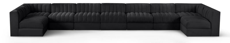 Black velvet modular sectional sofa with tufted cushions and curved armrests
