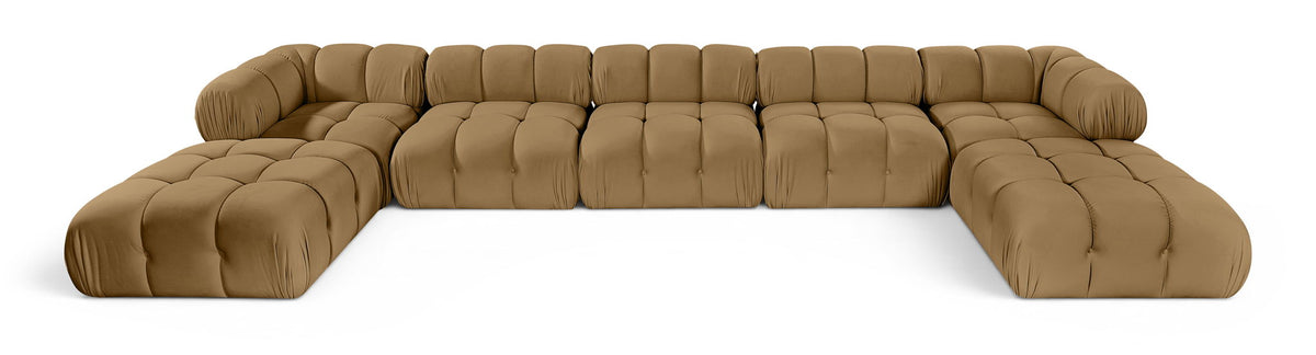 Tan modular sectional sofa with tufted cushions and rounded armrests, curved seating