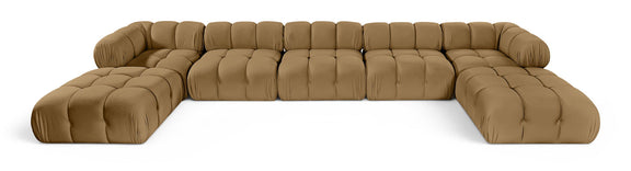 Tan modular sectional sofa with tufted cushions and rounded armrests, curved seating
