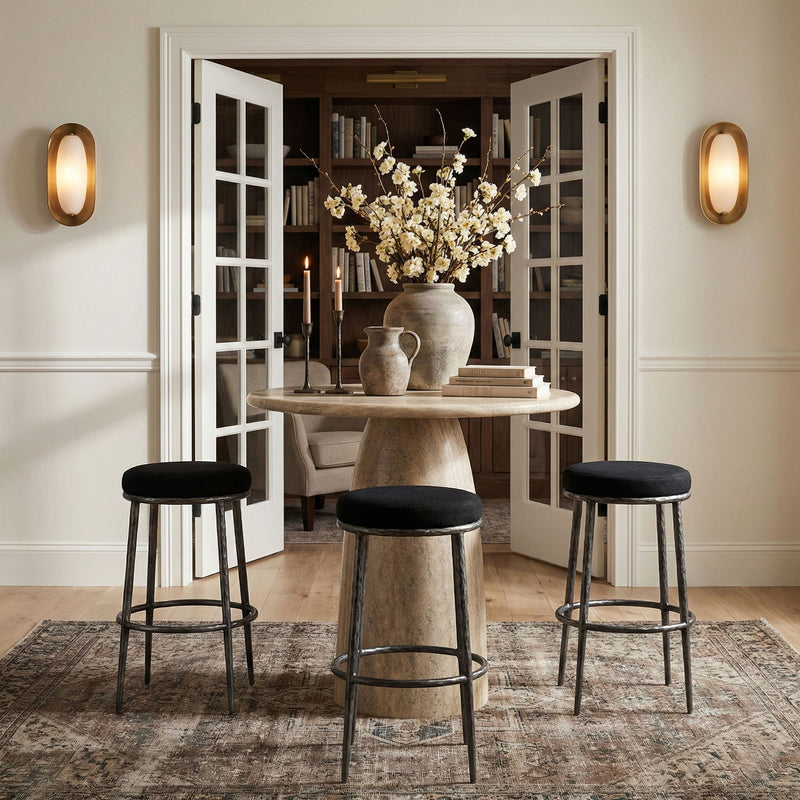 Set of three black upholstered backless bar stools with antique silver frames