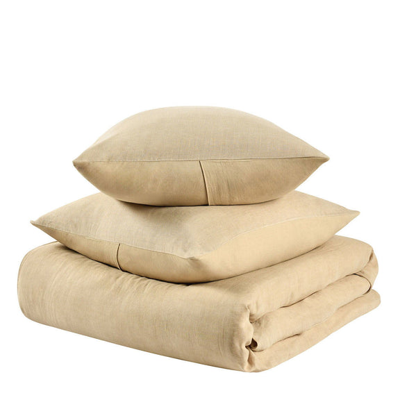 Stacked ochre hemp duvet and pillow shams with folded bedding edges