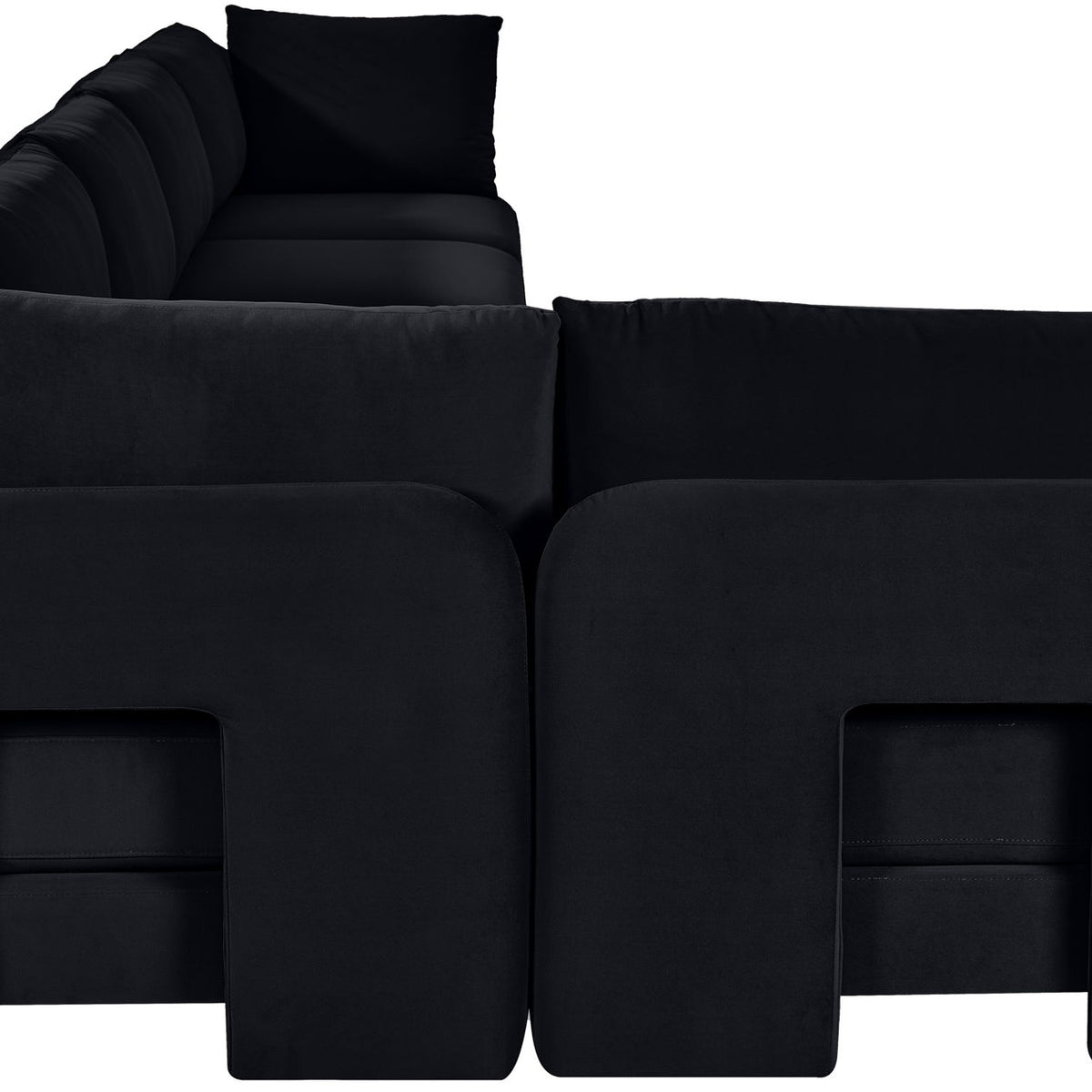 Black velvet armless sectional sofa with square back cushions and ottoman seats