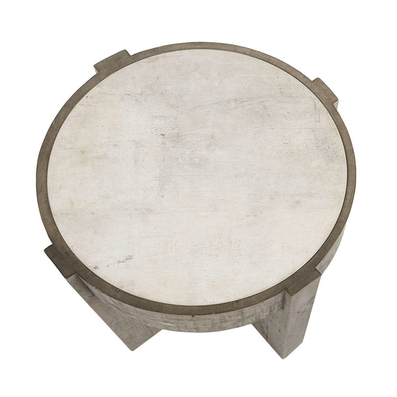 Round tabletop with distressed gray base supports and concrete-look top surface.