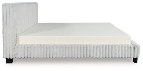 White upholstered bed frame with ribbed vertical sides, solid headboard, and mattress.