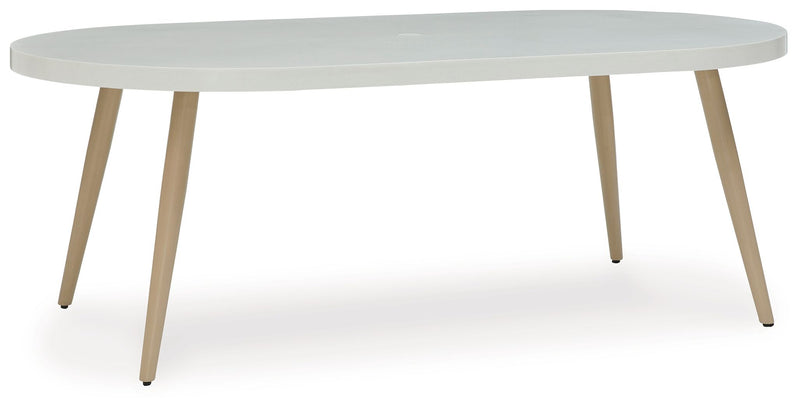 White oval dining table with smooth top and tapered wood legs