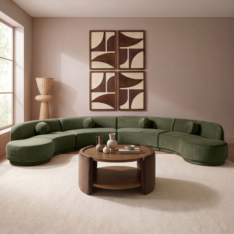 Green velvet sectional sofa with rounded chaise and plush cushions