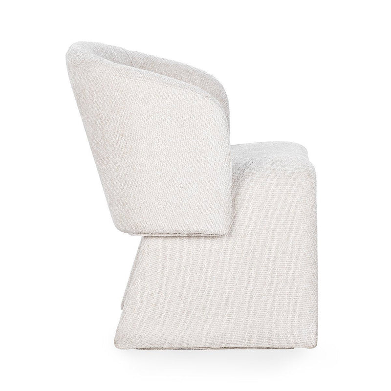 Upholstered dining chair in solid light fabric, close side view of arms