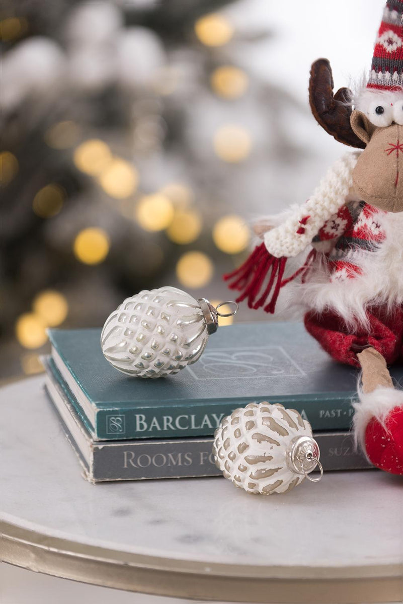 White glass hanging ball ornament with metal loop, shown with another ornament