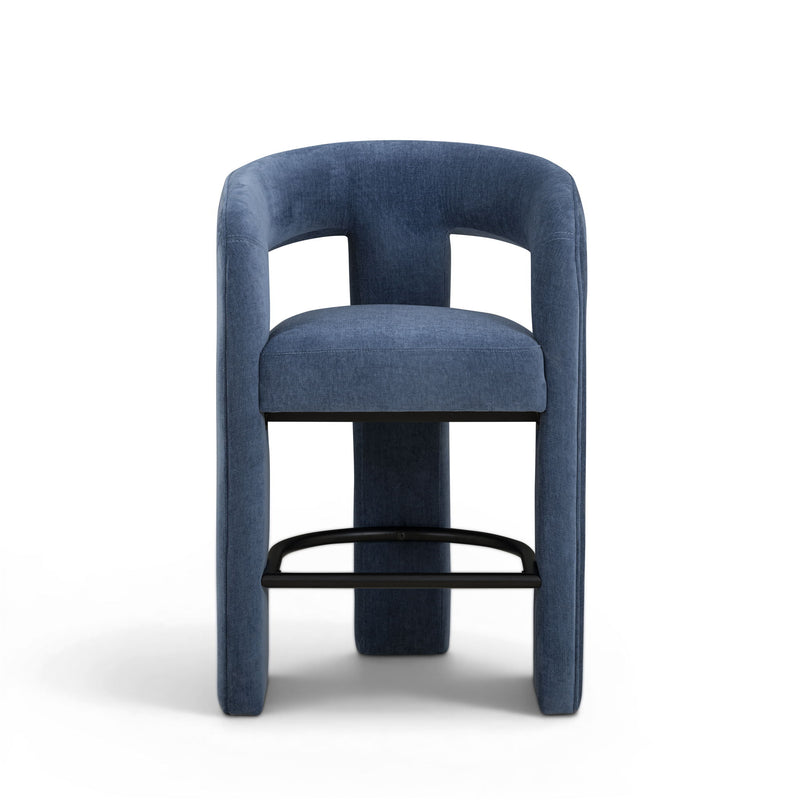 Blue upholstered stool with curved arms, padded seat, and black metal footrest