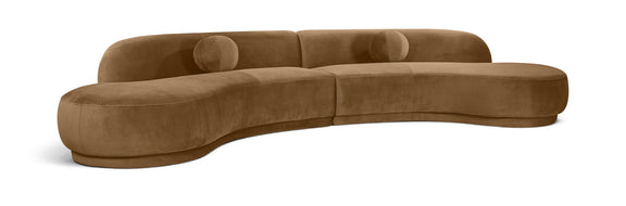 Beige velvet sectional sofa with tufted cushions and curved chaise profile