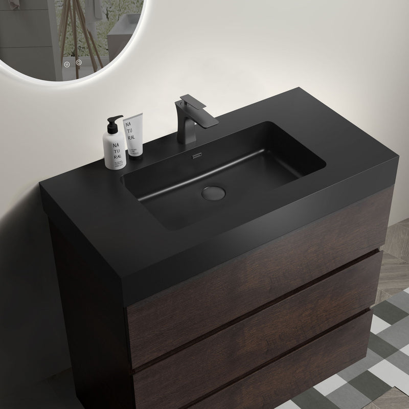 Freestanding bathroom vanity with black undermount sink, dark wood cabinet, pull-out drawers