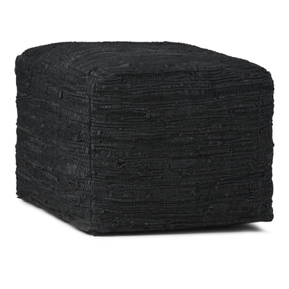 Square pouf ottoman in black textured fabric with rounded corners and top seam detail.