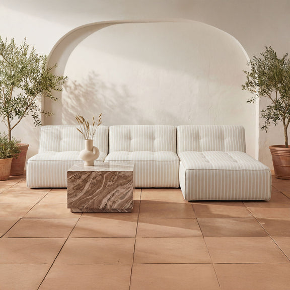 Outdoor slipper chair in beige with vertical brown stripe cushions and armrests