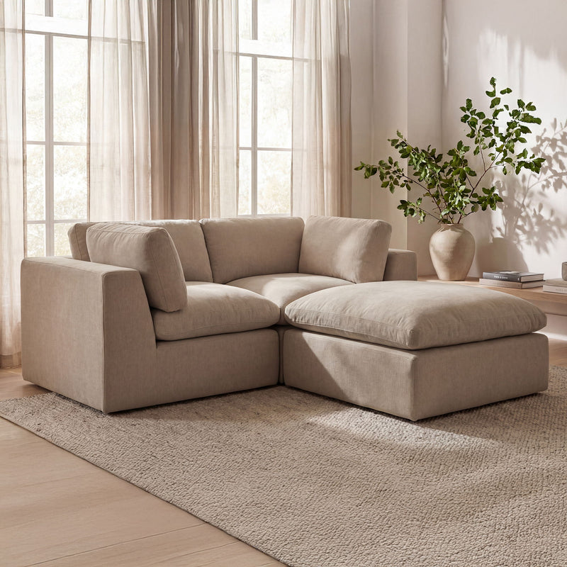 Beige fabric sectional with chaise ottoman piece and wide padded armrests