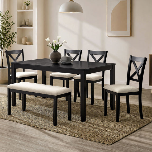 Rectangular dining table with four upholstered chairs, dark tabletop and light seat cushions