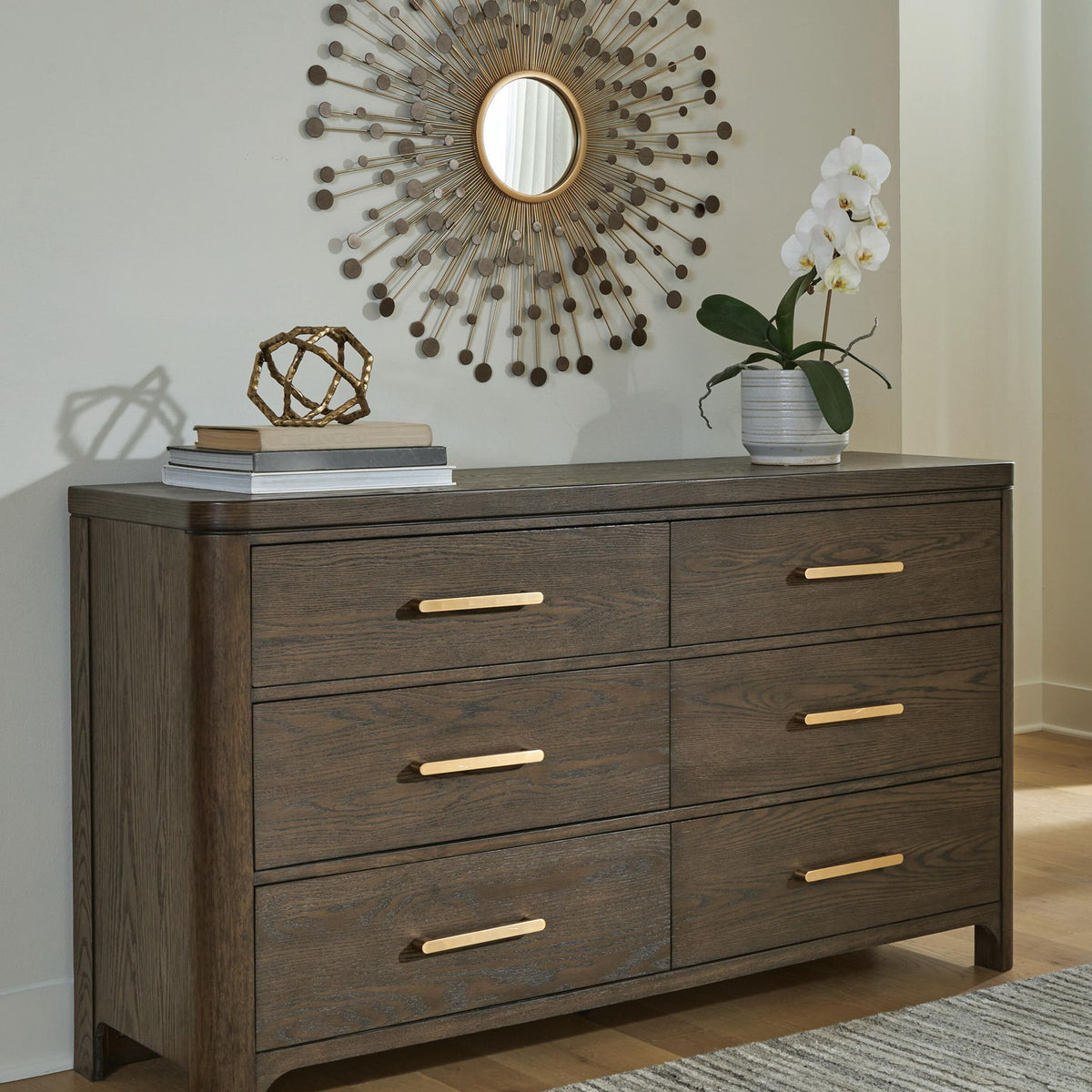 Dark brown wood dresser with six drawers and gold bar pulls