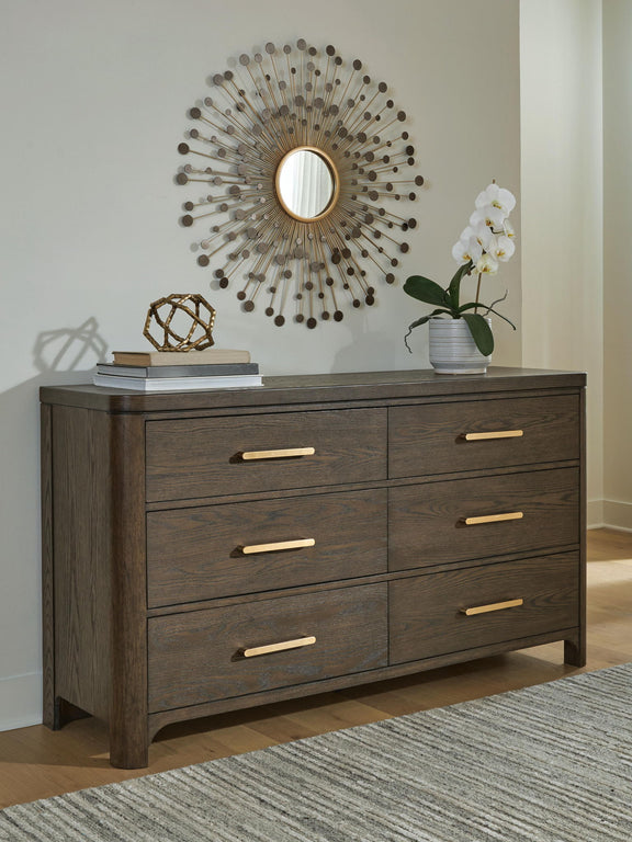 Dark brown wood dresser with six drawers and gold bar pulls