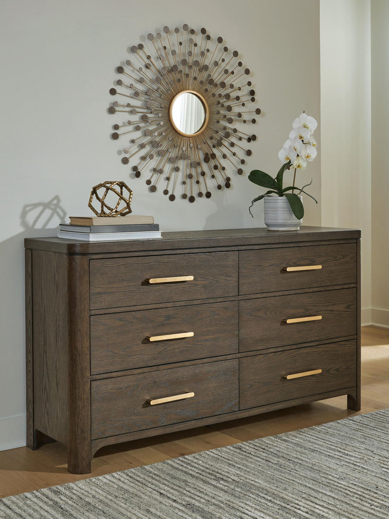 Dark brown wood dresser with six drawers and gold bar pulls