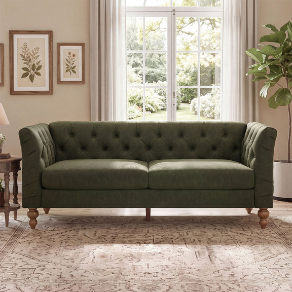 Dark green chesterfield-style sofa with tufted back, flared arms, and wooden legs