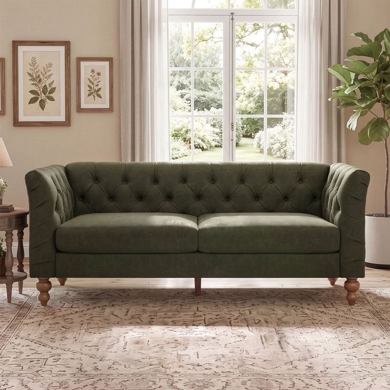 Dark green chesterfield-style sofa with tufted back, flared arms, and wooden legs