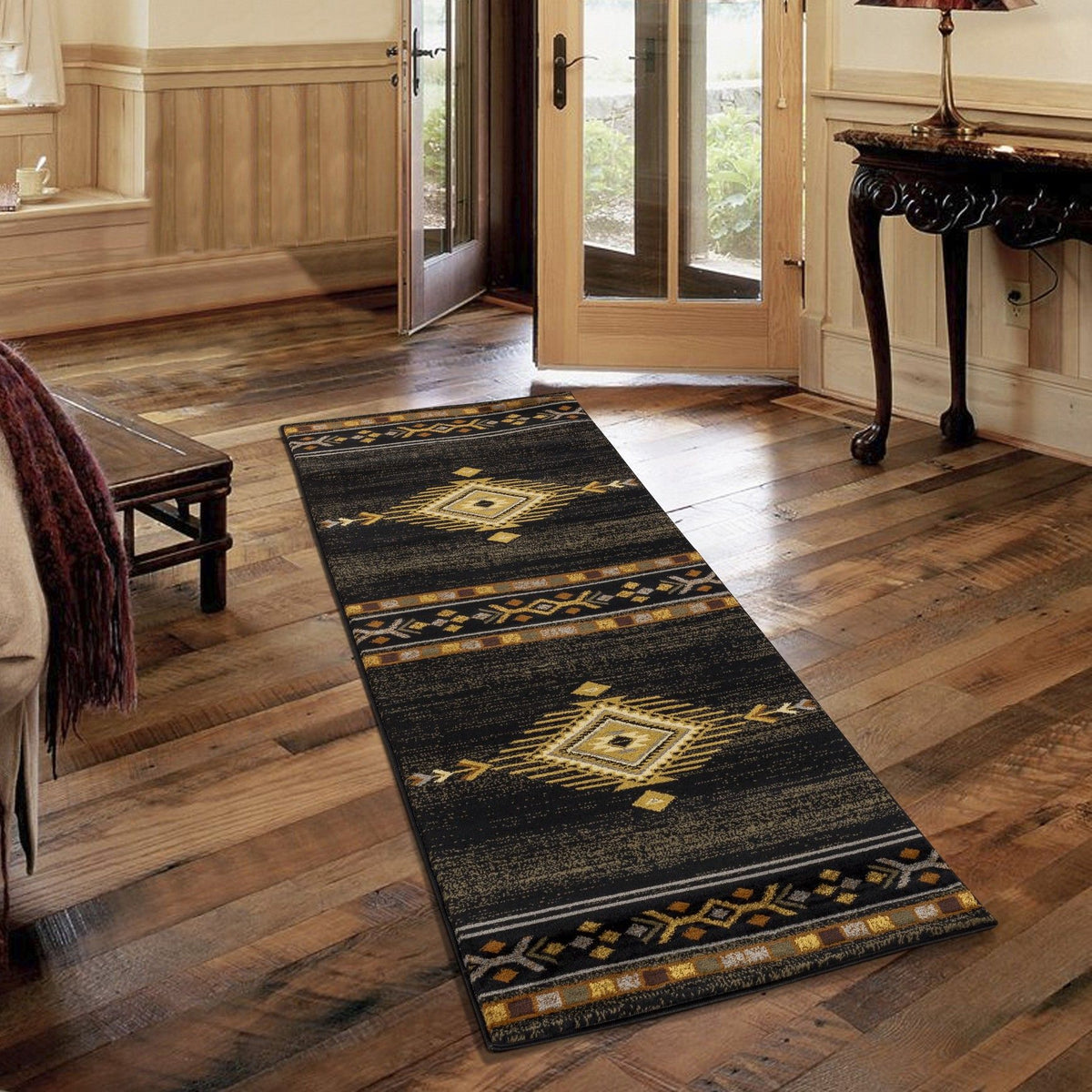 Southwest area rug with black base and gold geometric diamond pattern, long runner style