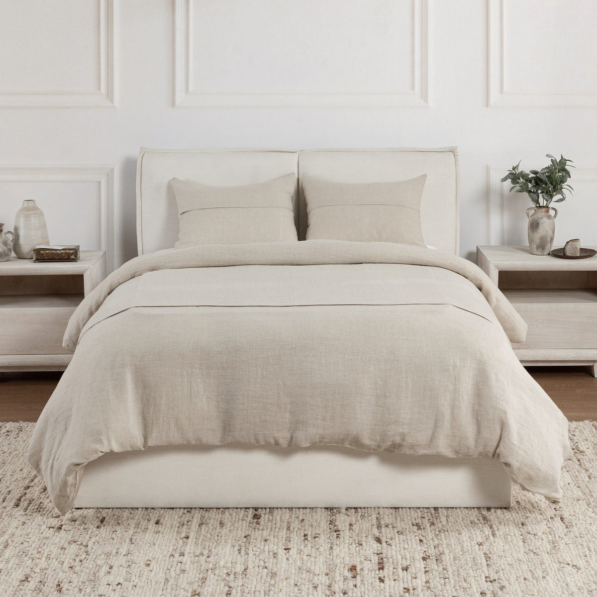 Beige linen sham pillows on a bed with coordinated bedding and pillows