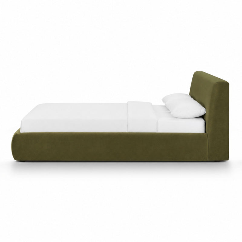 Dark green performance velvet bed with padded rails and two pillows on the mattress