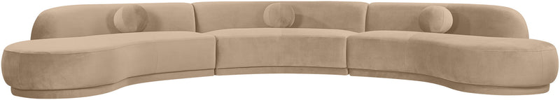 Beige velvet upholstered sectional with curved chaise and rounded seat cushions