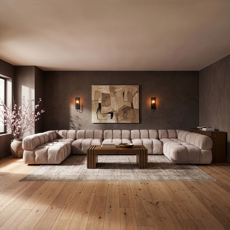 Beige modular U-shaped sectional sofa with tufted cushions and low chaise-style sections