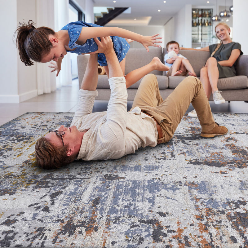 Abstract area rug with distressed ivory and blue pattern visible on the floor