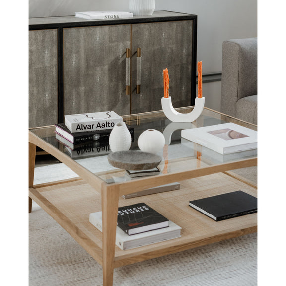 Natural wood coffee table with clear glass top and open lower shelf