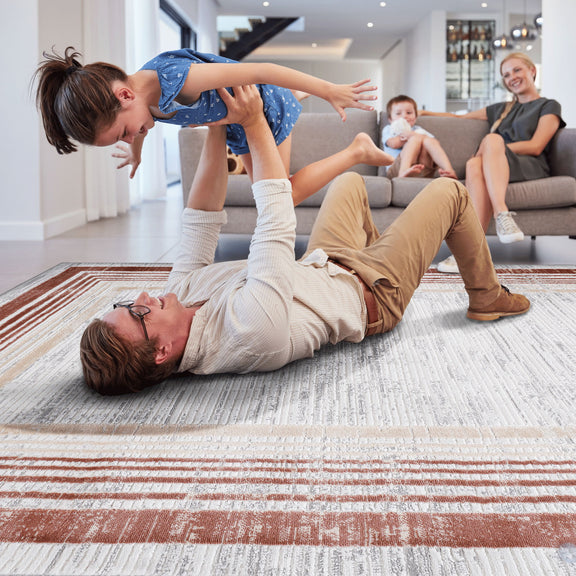Rust red and white bordered area rug with layered rectangular frame pattern under play.
