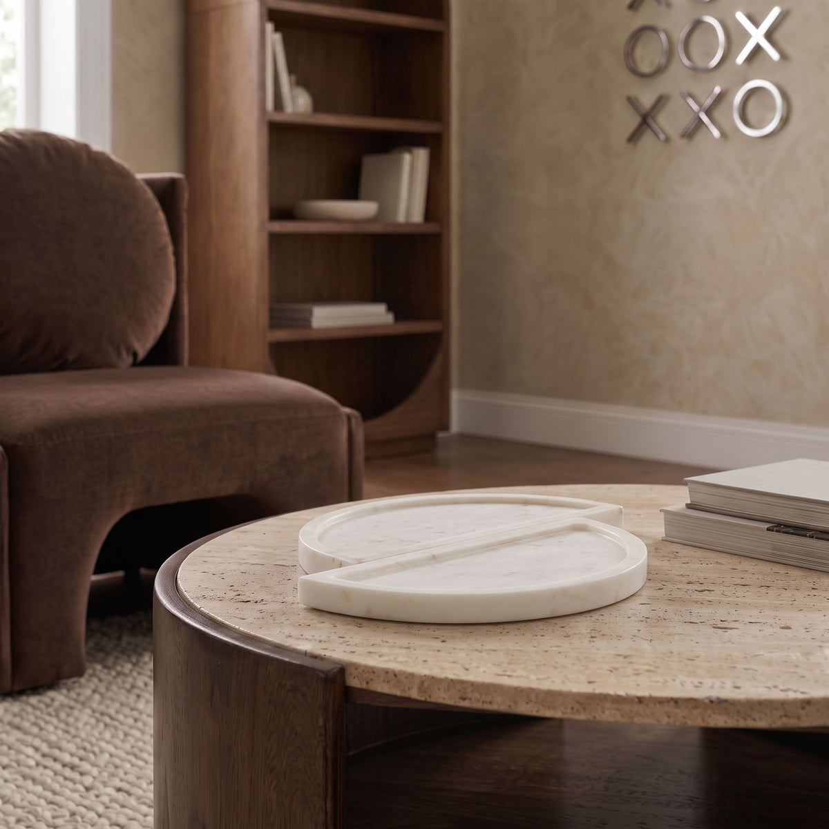 Beige marble tray resting on a coffee table, featuring two round split halves
