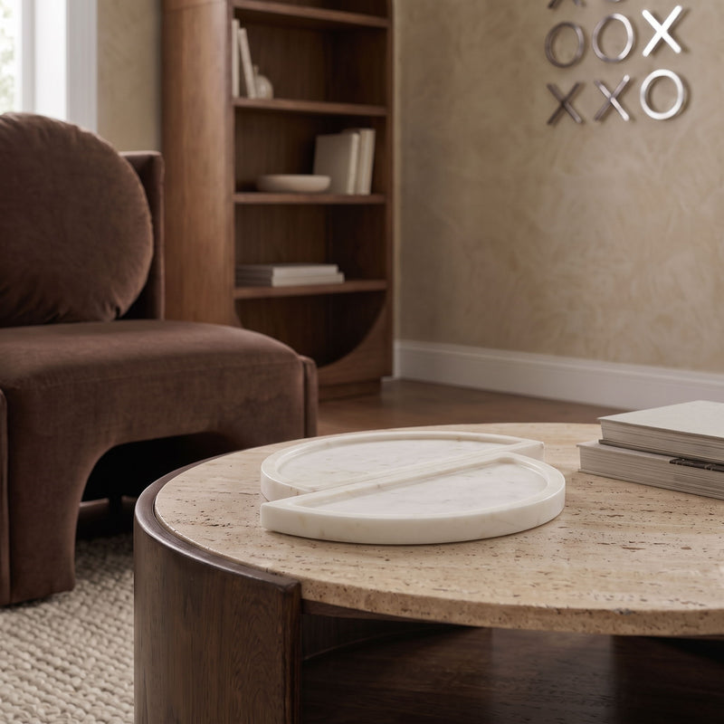 Beige marble tray resting on a coffee table, featuring two round split halves
