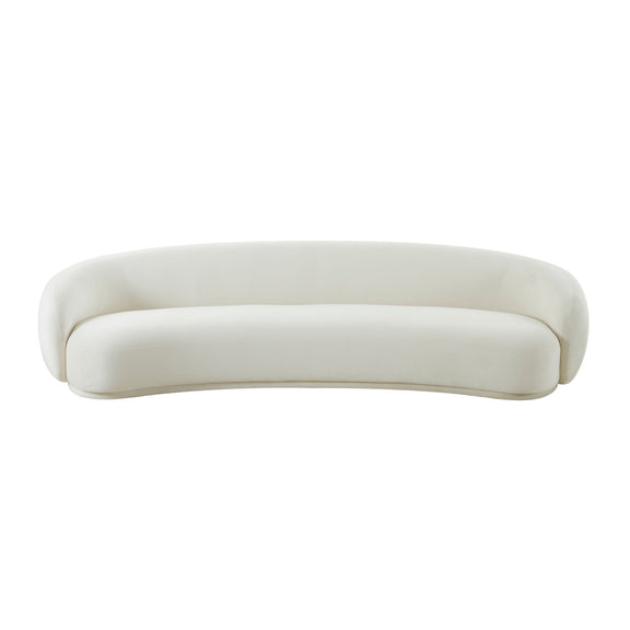 Beige velvet sofa with rounded arms and back, low curved silhouette