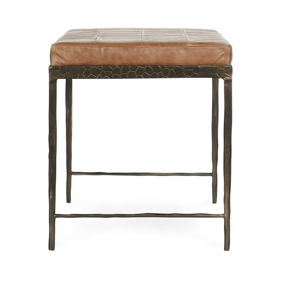 Brown leather bench with textured front skirt, padded seat, and dark legs