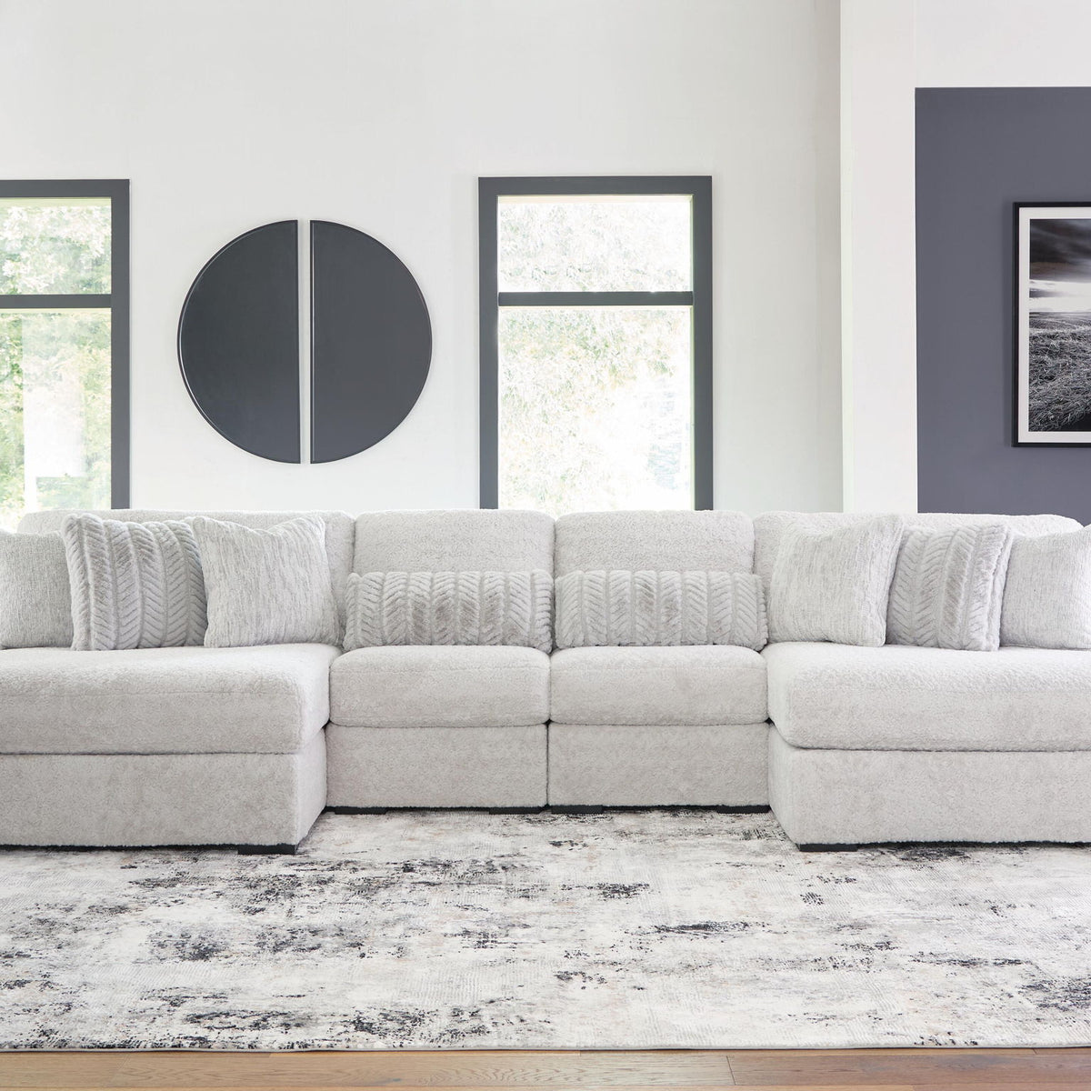 White plush sectional sofa with long chaise and tufted back cushions