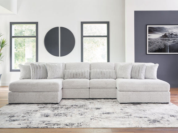 White plush sectional sofa with long chaise and tufted back cushions