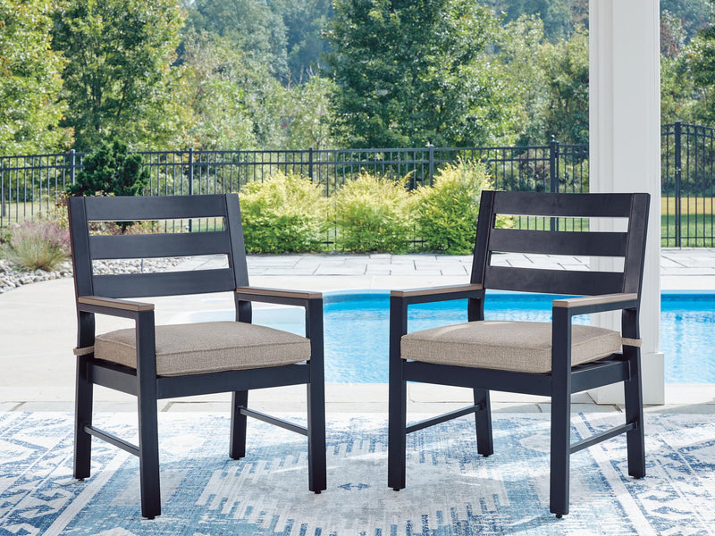 Two blue arm chairs with light gray cushions and slatted backs for outdoor seating