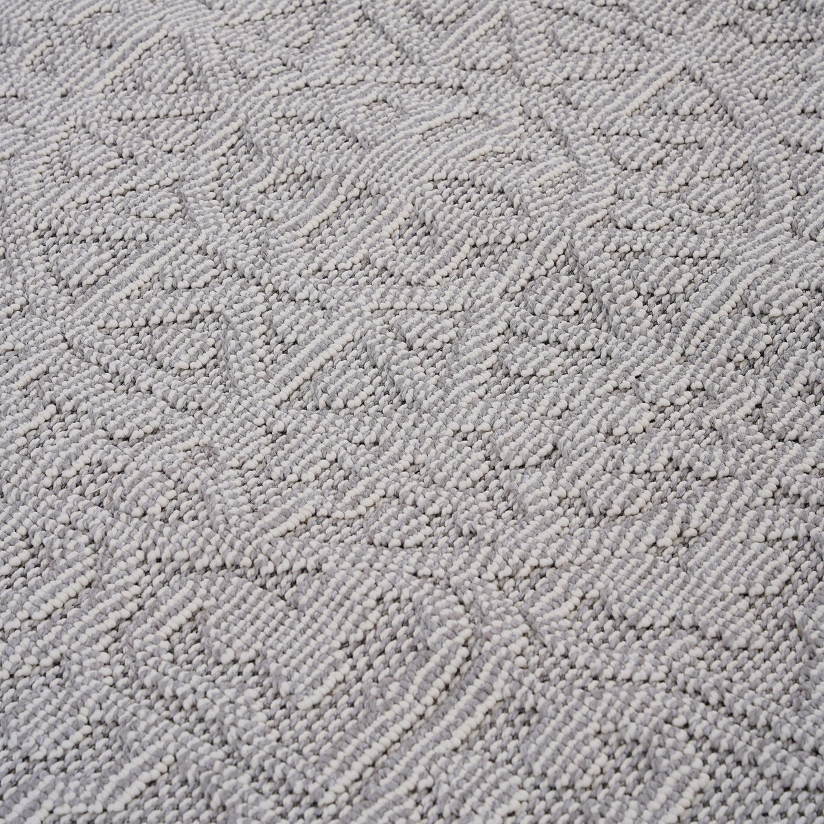 Medallion indoor/outdoor area rug in light gray with raised loop-texture geometric design