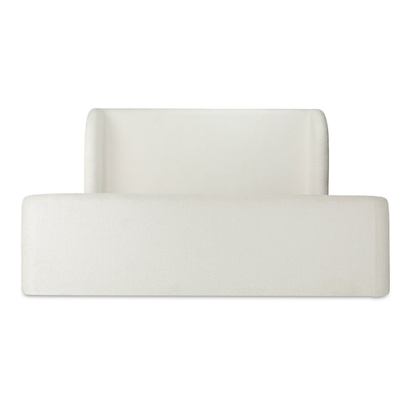 Cream upholstered king bed with tall square headboard and low front panel