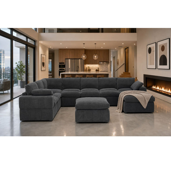 Dark gray sectional sofa with two chaise ends, an ottoman and toss pillow