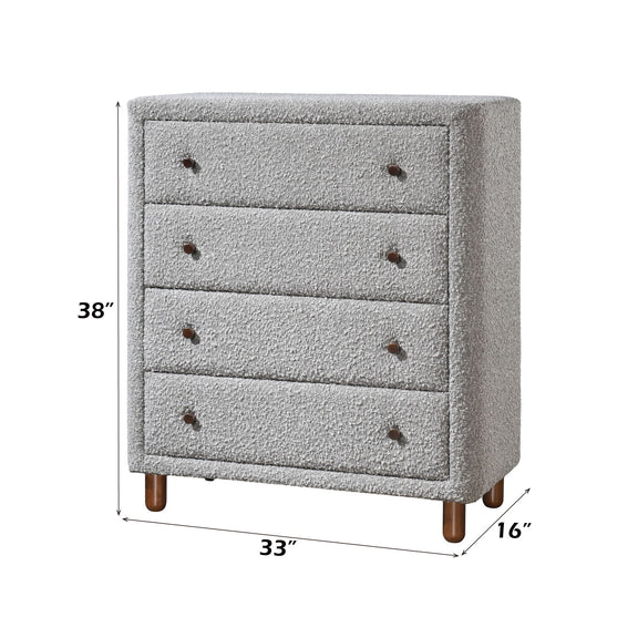 Gray upholstered 4-drawer chest with button accents and wooden legs