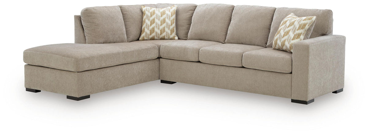 Sleeper sectional sofa with corner chaise, light brown upholstery, two patterned back pillows