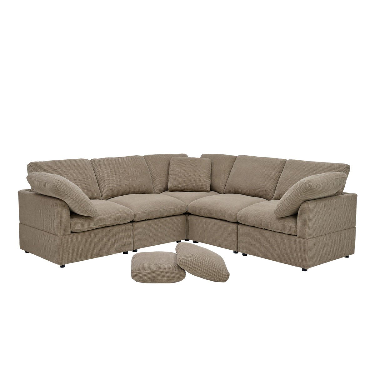 Modular camel sofa with corner seating, cushioned arms, and two loose pillows.