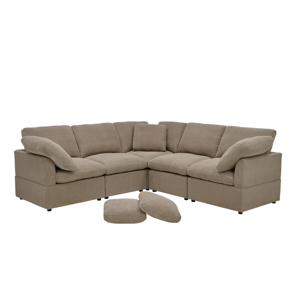Modular camel sofa with corner seating, cushioned arms, and two loose pillows.
