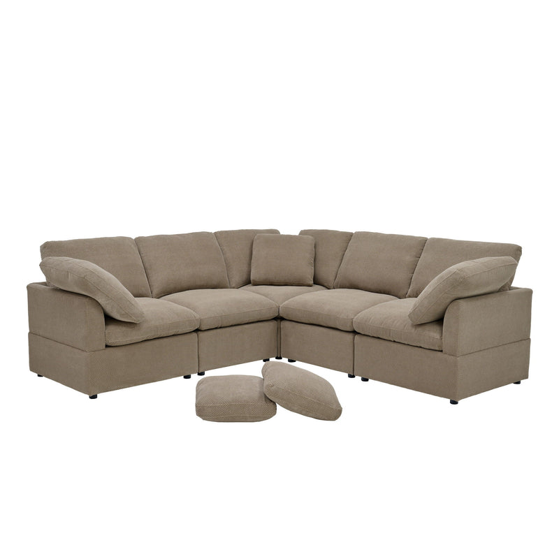 Modular camel sofa with corner seating, cushioned arms, and two loose pillows.