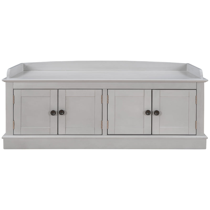 Light gray storage bench with four paneled doors and a raised back edge