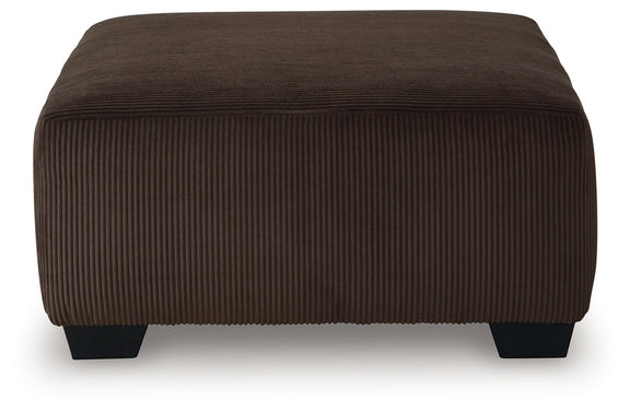 Dark brown ottoman with vertical ribbed fabric upholstery and low square legs